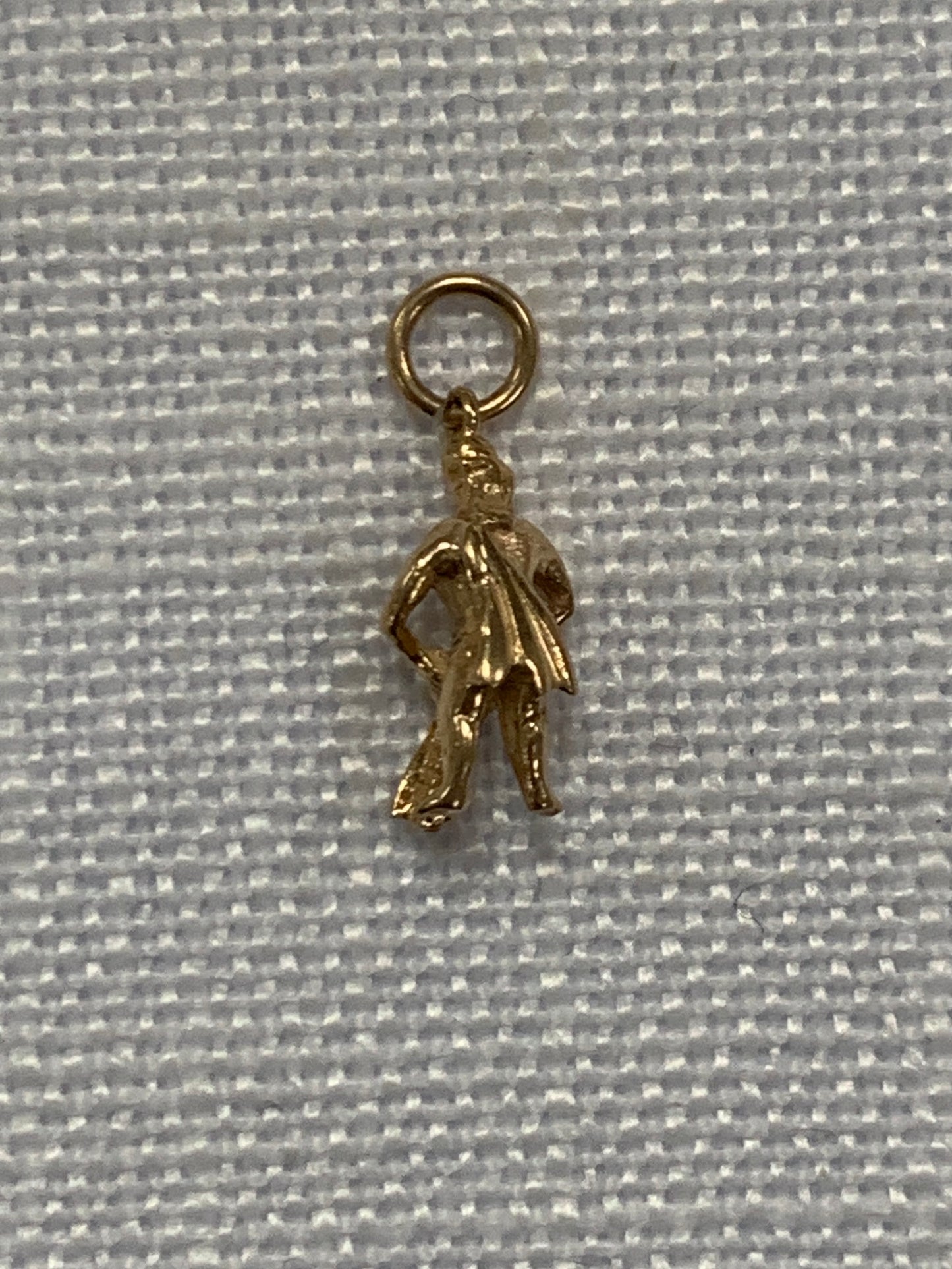 Man pouring water from bowl gold charm pendant