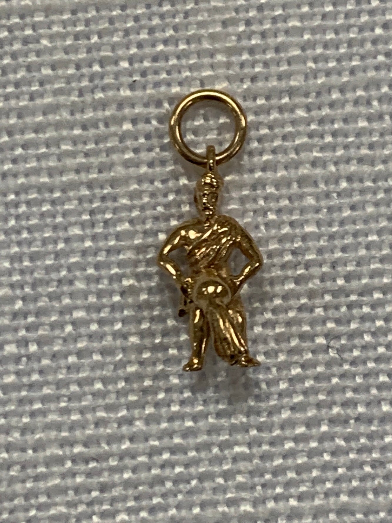 Man pouring water from bowl gold charm pendant