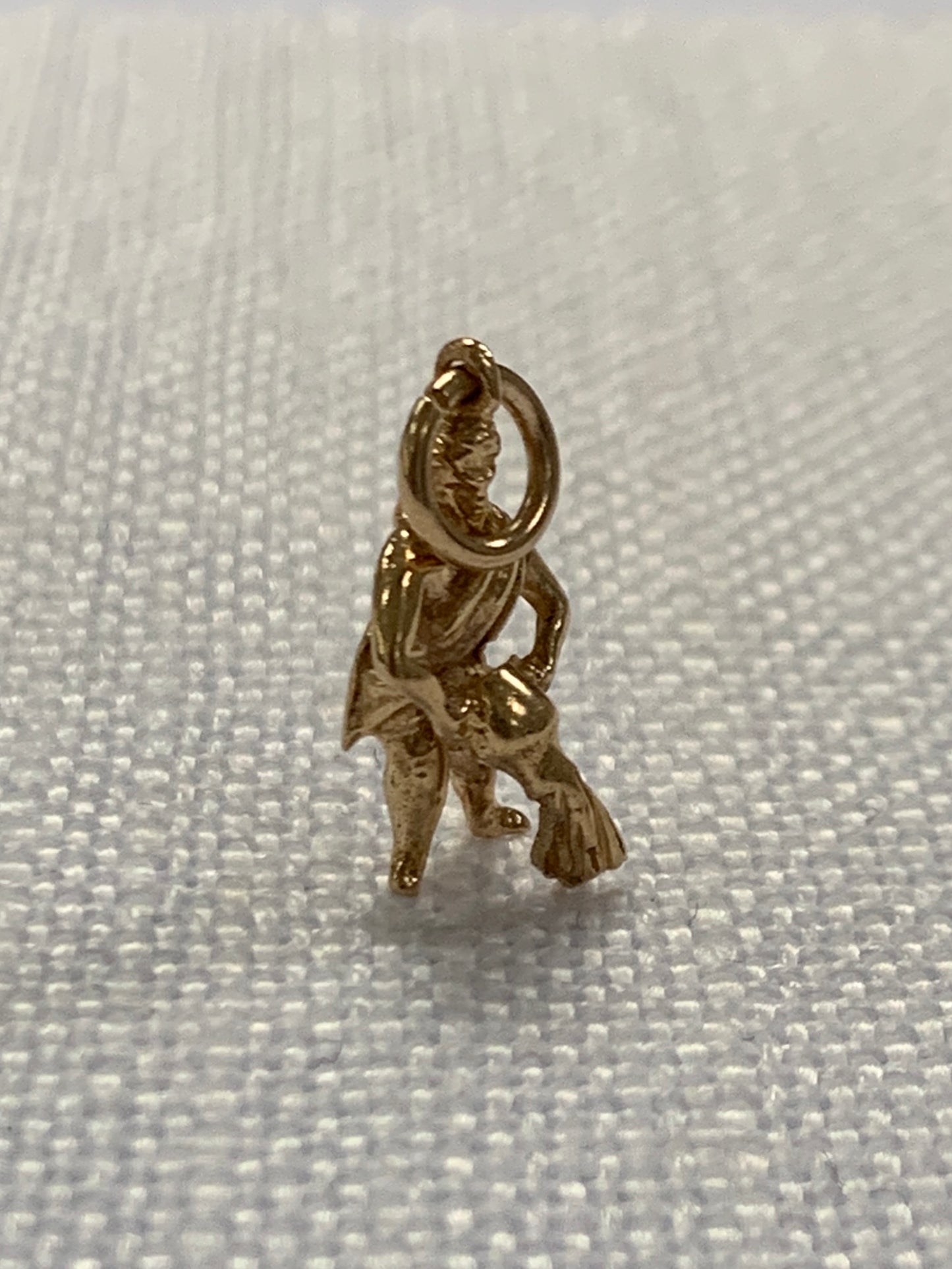 Man pouring water from bowl gold charm pendant